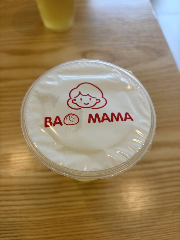 Cup of tea with bao mama logo on top in red letters. 